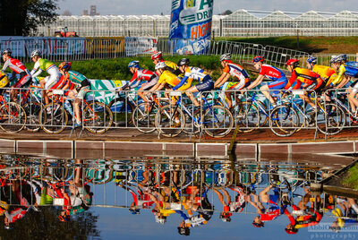 The juniors get underway over one of a number of water crossings. Pijnacker, Netherlands. 2005 Cyclocross — AbbiOrca cycling race photography