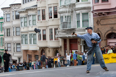 Race announcer extraordinaire Richard Fries throws gifts to the crowd. SF Grand Prix — AbbiOrca cycling race photography